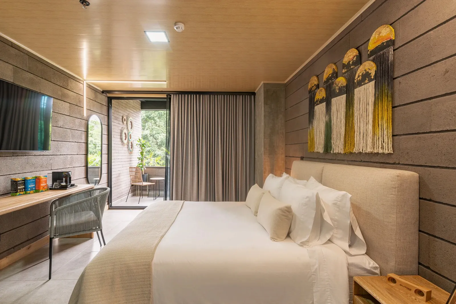 Superior Suite with a queen bed, desk and balcony access at Living by Armóniko
