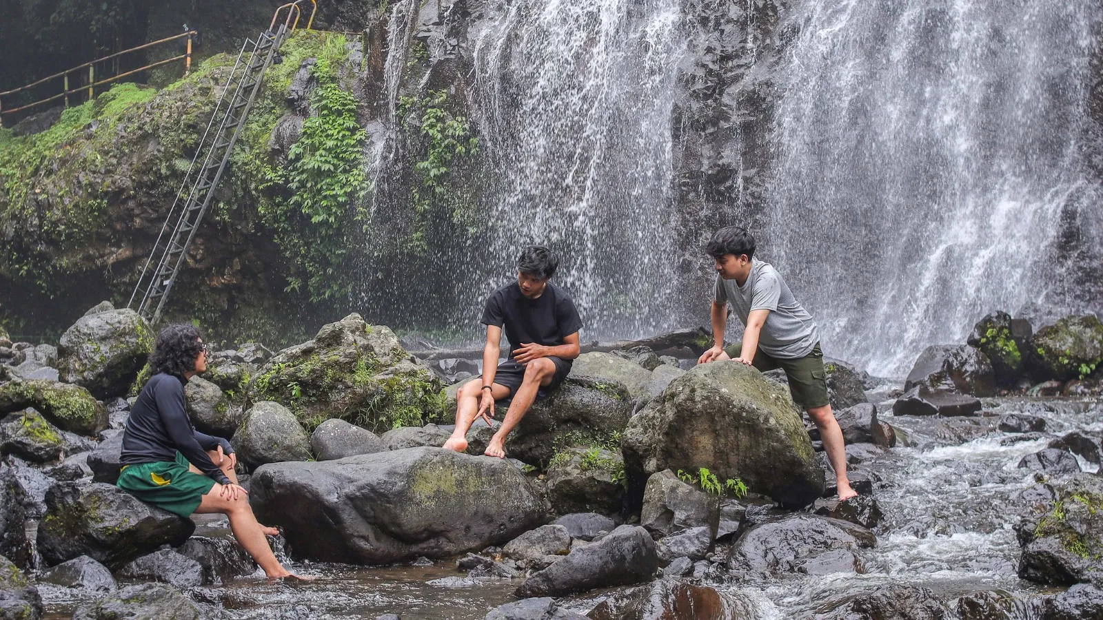 Travelers resting by a natural waterfall, Green Connection tour